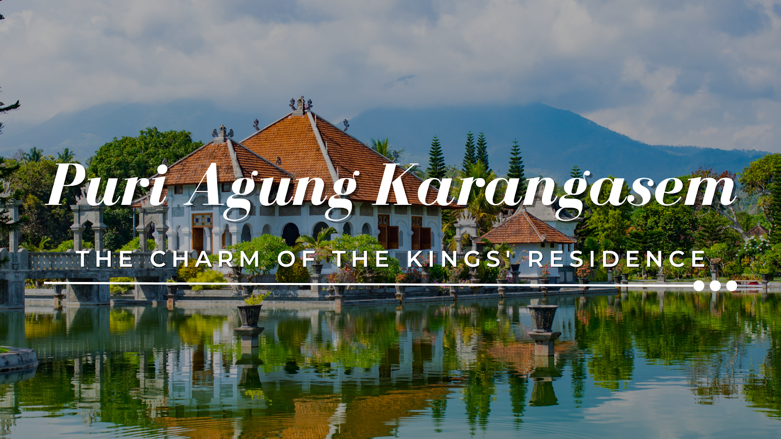 Panoramic view of Puri Agung Karangasem, showcasing majestic mountains and a serene fish pond.