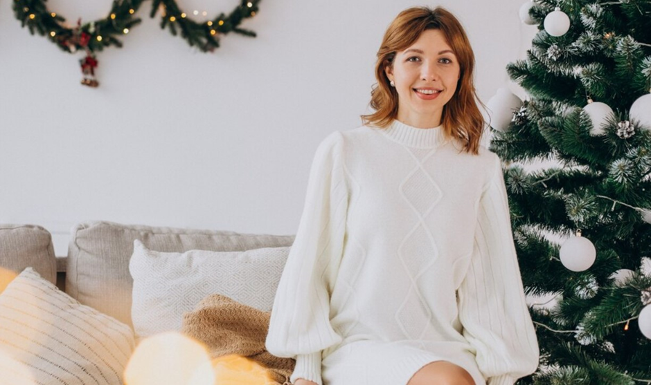 A woman wearing a knit dress for a White Christmas party theme.