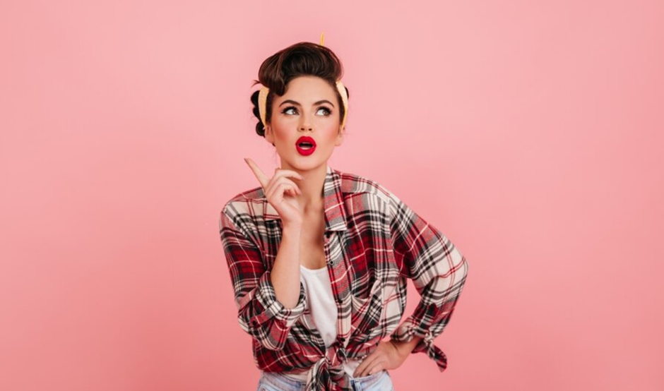 A woman wearing bold makeup and 80s outfit.