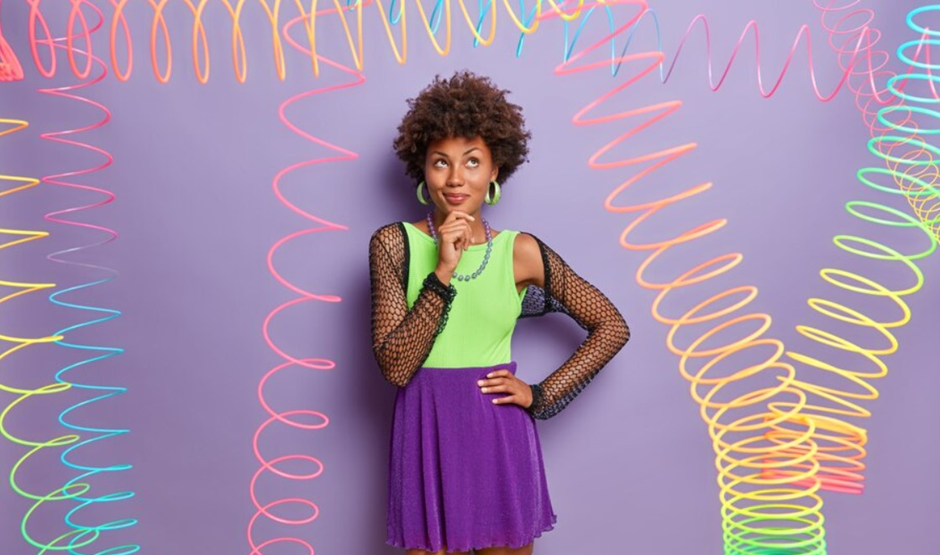 A woman wearing neon-coloured sleeveless T-shirt and mini skirt.
